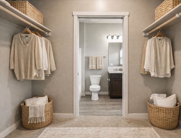 A bathroom with a toilet, sink, and towels.