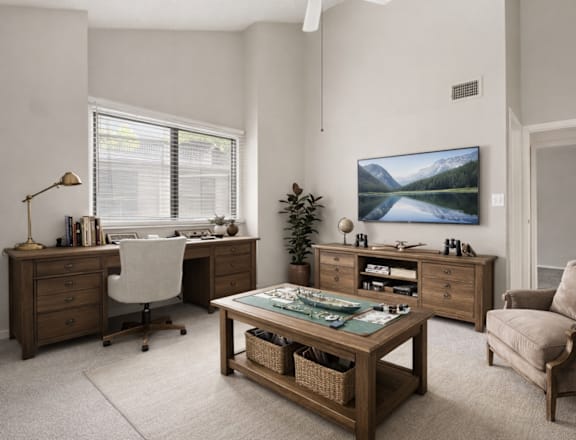 A room with a desk, chair, and a large painting on the wall.