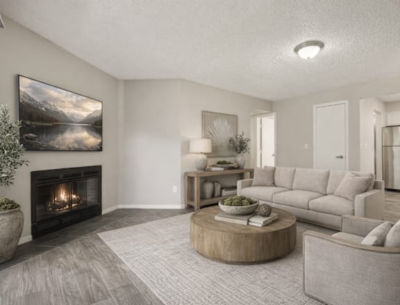 A modern living room with a fireplace and a painting on the wall.