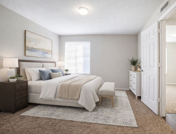 A bedroom with a bed, nightstand, and a painting on the wall. at Haven Pointe Apartments, Utah, 84401