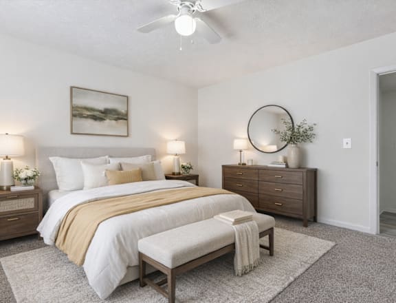 A bedroom with a bed, nightstands, and a rug.