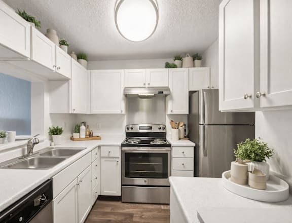 A modern kitchen with stainless steel appliances and white cabinetry.