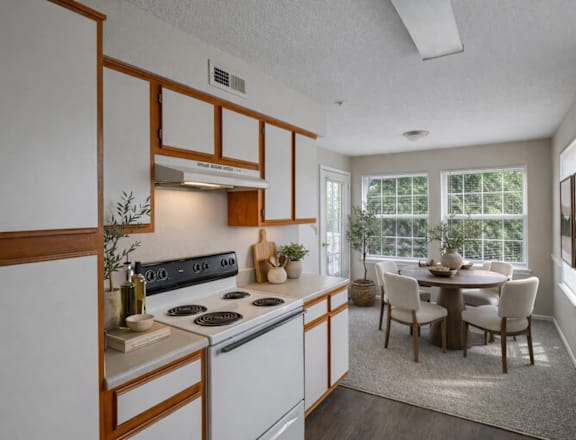 A kitchen with a dining table and chairs.
