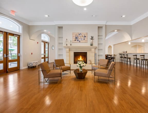 A living room with a fireplace and chairs.