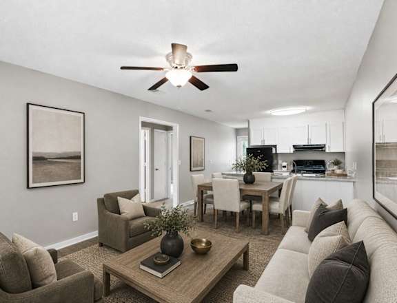A living room with a couch, chairs, and a coffee table.