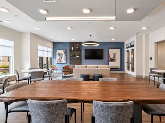 A conference room with a long table and chairs.