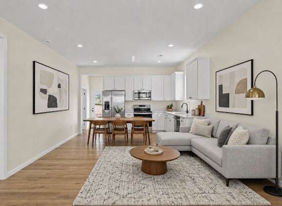 A modern living room with a grey sofa and a coffee table.
