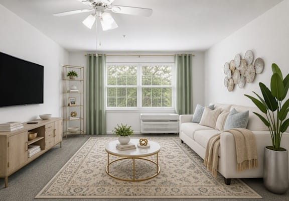 A living room with a white ceiling fan, a large window with green curtains, a white sofa, and a wooden coffee table.