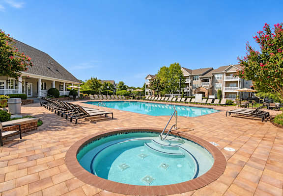 A round pool with a fountain in the middle of a patio.