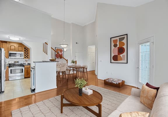 A modern kitchen with a dining table and chairs.