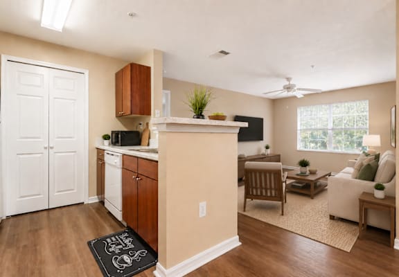 A kitchen with a white refrigerator and a white door.