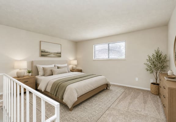 A bedroom with a large bed and a white crib.