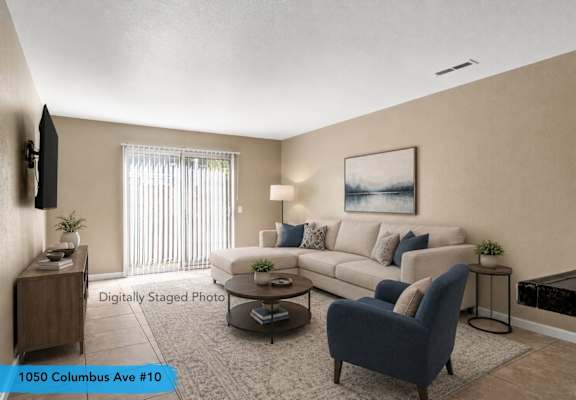 A living room with a sofa, armchair, and coffee table.