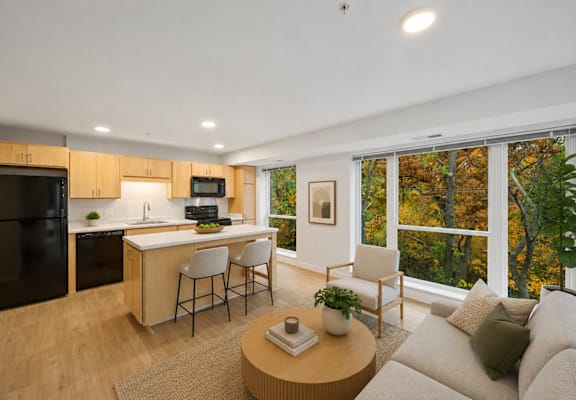 A modern kitchen with a dining area and a couch.