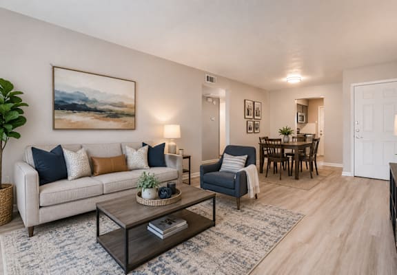 A living room with a couch, chair, and coffee table.