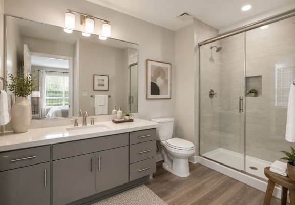 A modern bathroom with a white toilet and a walk-in shower.