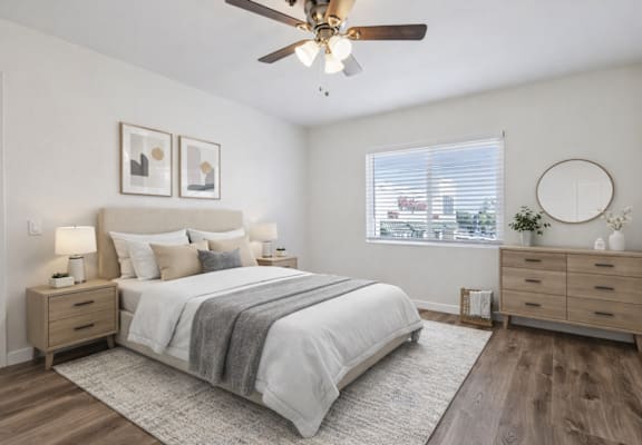 A bedroom with a bed, dresser, and window.
