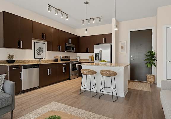 A modern kitchen with brown cabinets and a white refrigerator.
