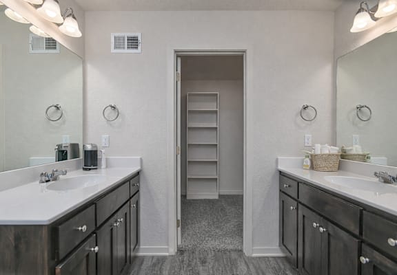 A bathroom with two sinks and a large mirror.