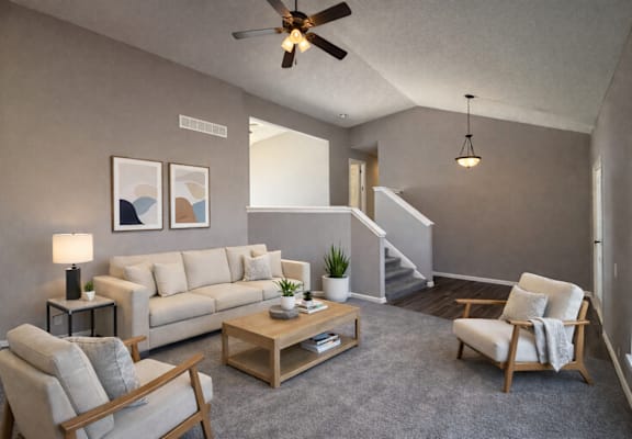 A living room with a couch, chair, and a coffee table.