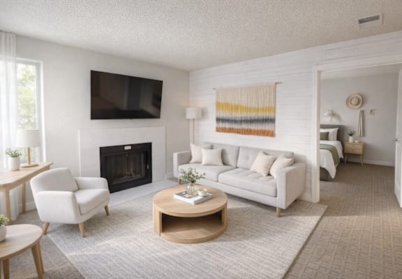 A living room with a fireplace, a couch, a chair, and a coffee table.