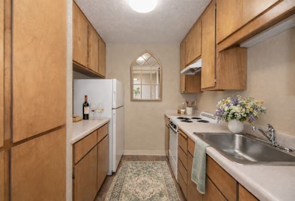 Kitchen with wooden cabinets at Lodi Commons Senior Living, Lodi, 95240