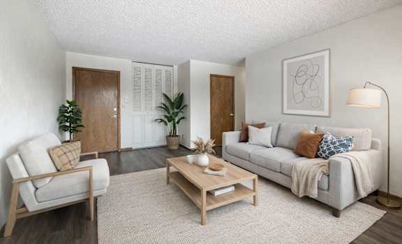 A living room with a couch, chair, and coffee table.