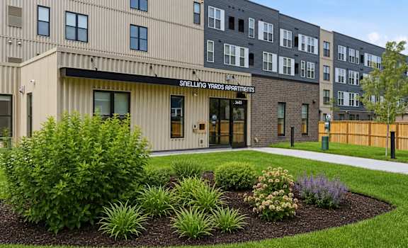 A building with the sign "Shell Landing Yards Apartments" in front of it.