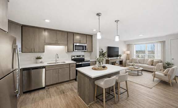 A modern kitchen with a dining area and a living room.