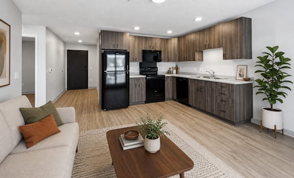 A modern kitchen with a refrigerator, oven, and sink.