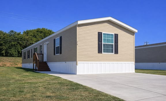 A small house with a brown roof and white trim.