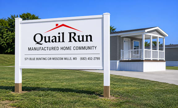 A sign for Quail Run Manufactured Home Community with a house in the background.