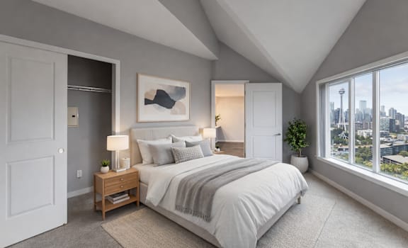 A bedroom with a large bed and a view of the city.