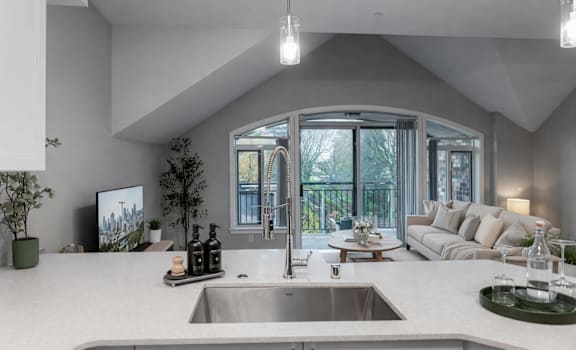 A modern kitchen with a large island and a sink.