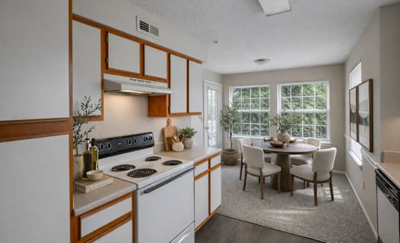 A kitchen with a dining table and chairs.