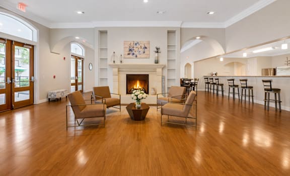 A living room with a fireplace and chairs.
