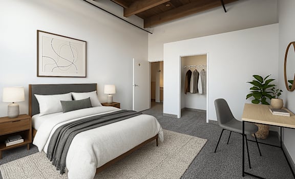 Virtually staged loft bedroom with wood ceiling beams and a walk-in closet at Off Broadway Apartments