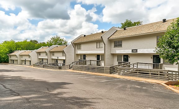A row of white houses with black railings.