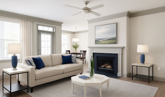 A living room with a white couch, a fireplace, and a painting on the wall.