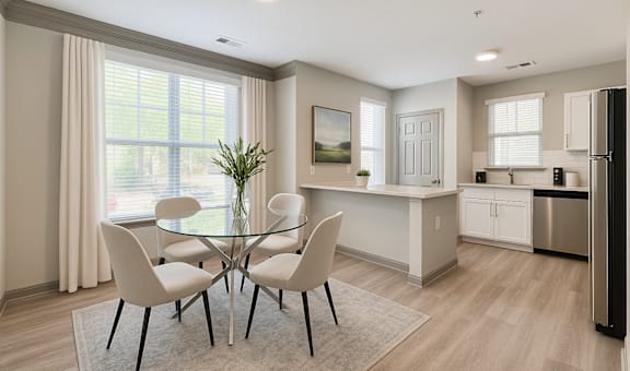 A modern kitchen with a glass dining table and chairs.