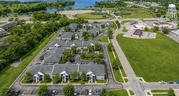 A bird's eye view of a residential area with houses, roads, and a water tower.