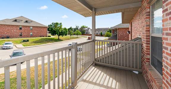 A balcony with a railing and a roof over it.