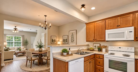 A kitchen with wooden cabinets and a white dishwasher.