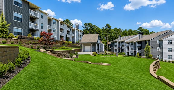 A grassy area in front of apartment buildings.