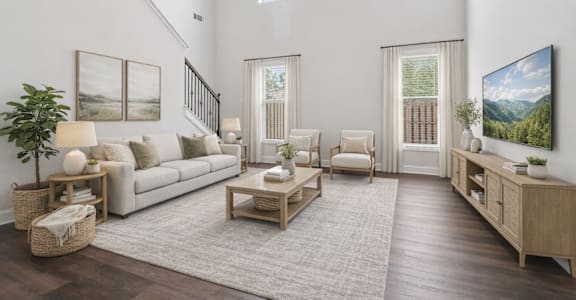 A living room with a couch, chairs, and a TV.