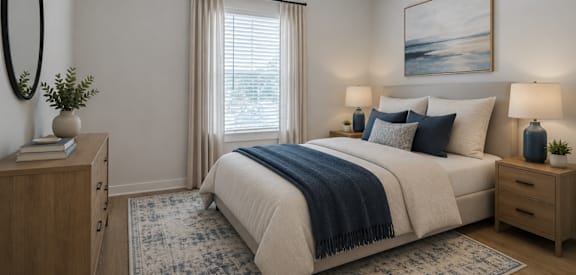 A bedroom with a large bed, a ceiling fan, and a painting on the wall.