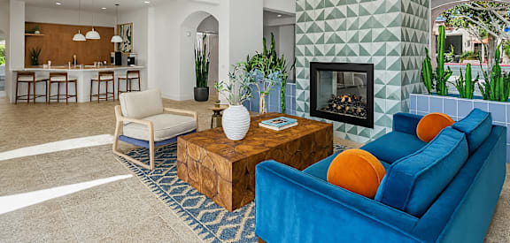 A living room with a blue couch and a wooden coffee table.