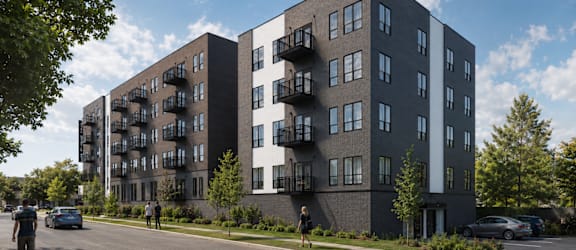 A modern apartment building with balconies on the second floor.