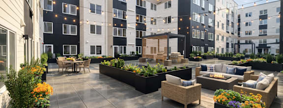 A courtyard with a table and chairs surrounded by buildings.