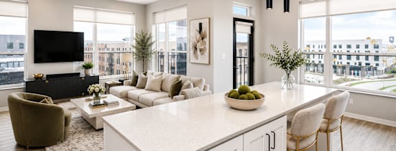 A modern kitchen with a large island and a view of the city.